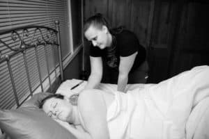 Davis County birth doula providing support for pregnant woman in labor